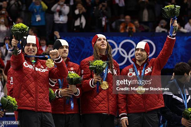 Charles Hamelin, Olivier Jean, Francois Hamelin, Francois-Louis Tremblay and Guillaume Bastille of Canada celebrate the gold medal after the Men's...