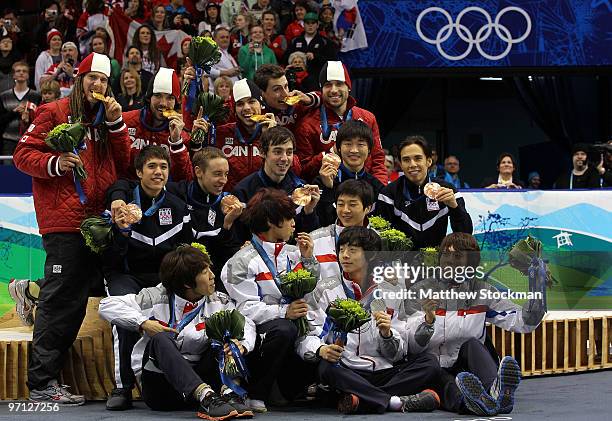 Charles Hamelin, Olivier Jean, Francois Hamelin, Francois-Louis Tremblay and Guillaume Bastille of Canada celebrate the gold medal with silver...