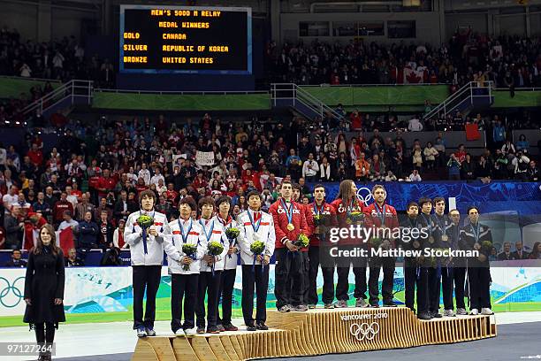 Charles Hamelin, Olivier Jean, Francois Hamelin, Francois-Louis Tremblay and Guillaume Bastille of Canada celebrate the gold medal with silver...