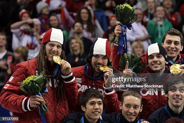 Charles Hamelin , Olivier Jean , Francois Hamelin and Guillaume Bastille of Canada celebrate the gold medal after the Men's 5000m Relay Short Track...