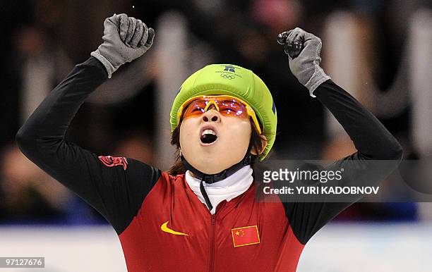 Gold medallist, China's Meng Wang celebrates at the end of the Ladies' 1000 m short-track final at the Pacific Coliseum in Vancouver, during the 2010...