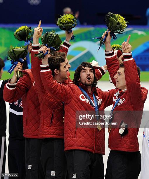 Charles Hamelin of Canada celebrates the gold medal with team mates Olivier Jean, Francois Hamelin, Francois-Louis Tremblay and Guillaume Bastille...