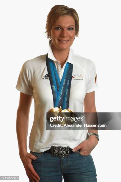 Alpine skier Maria Riesch of Germany poses with her gold medals for the ladies' super combined and ladies' slalom on day 15 of the Vancouver 2010...