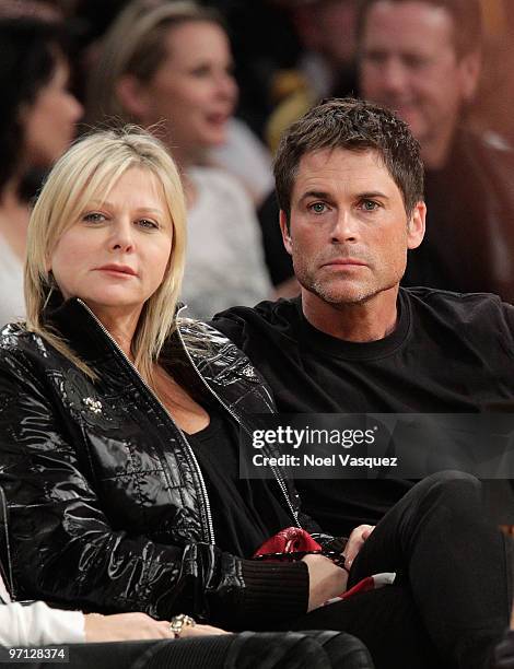 Rob Lowe and his wife attend a game between the Philadelphia 76ers and the Los Angeles Lakers at Staples Center on February 26, 2010 in Los Angeles,...