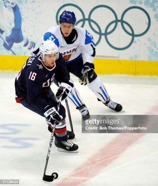 Joe Pavelski of the USA with Valtteri Filppula of Finland during the ice hockey men's semifinal game between the United States and Finland on day 15...