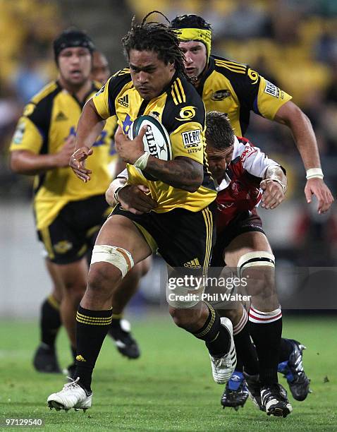 Rodney So'oialo of the Hurricanes breaks away from the tackle of Karl Lowe of the Lions during the round three Super 14 match between the Hurricanes...