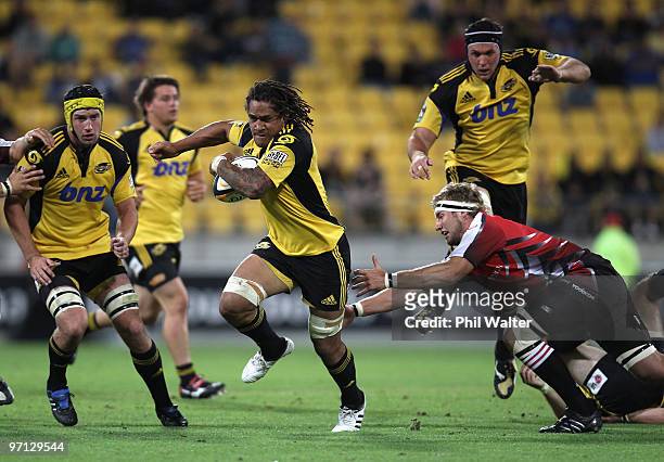 Rodney So'oialo of the Hurricanes breaks away from the tackle of Robert Kruger of the Lions during the round three Super 14 match between the...