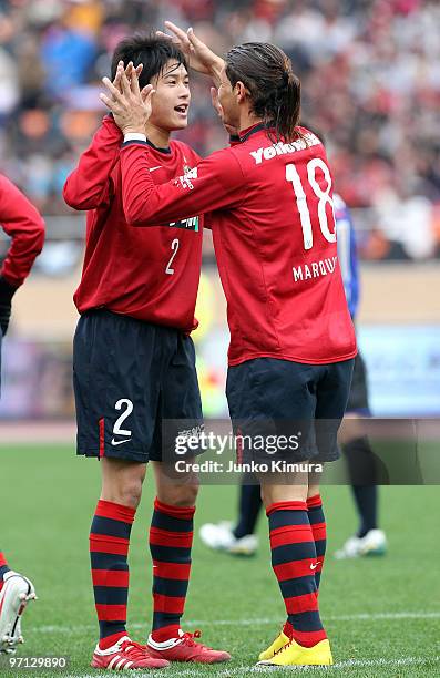 Marquinhos of Kashima Antlers celebrates with Atsuto Uchida after scoring a goal during the Xerox Super Soccer match between Kashima Antlers and...