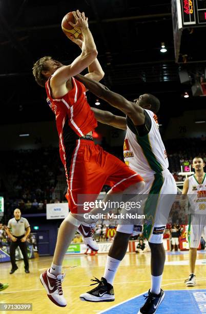 Larry Davidson of the Hawks is fouled by Rolan Roberts of Townsville during game three of the NBL semi final series between the Wollongong Hawks and...