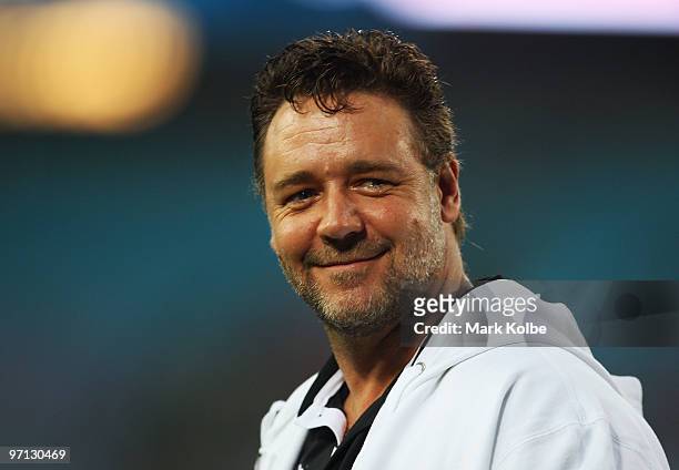 Russell Crowe smiles to the crowd during the Rabbitohs warm-up before the NRL Charity Shield match between the South Sydney Rabbitohs and the St...