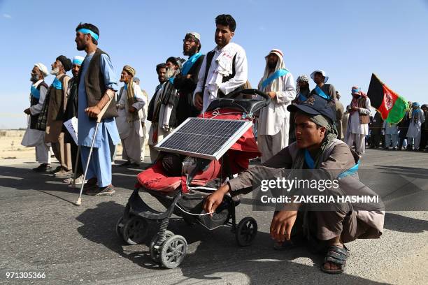 This picture taken on June 8, 2018 shows Afghan peace activists shouting slogans in demand to an end to the war as they start their march from...