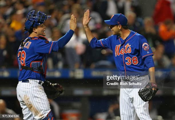 Devin Mesoraco and Anthony Swarzak of the New York Mets celebrate their 2-0 win over the New York Yankees during a game at Citi Field on June 10,...