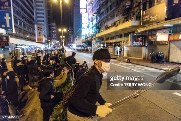 In this photo taken on February 9 a protestor holds a folding chair as he and others gather during clashes with police, later dubbed the "Fishball...
