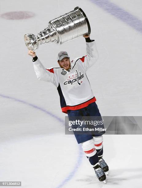 John Carlson of the Washington Capitals hoists the Stanley Cup after Game Five of the 2018 NHL Stanley Cup Final at T-Mobile Arena on June 7, 2018 in...