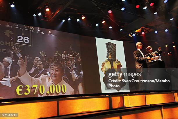 Man from China makes his bid at 370.000 Euro for a Cuban humidor during an auction of humidors and gala dinner smoke Cuban cigars at the end of the...