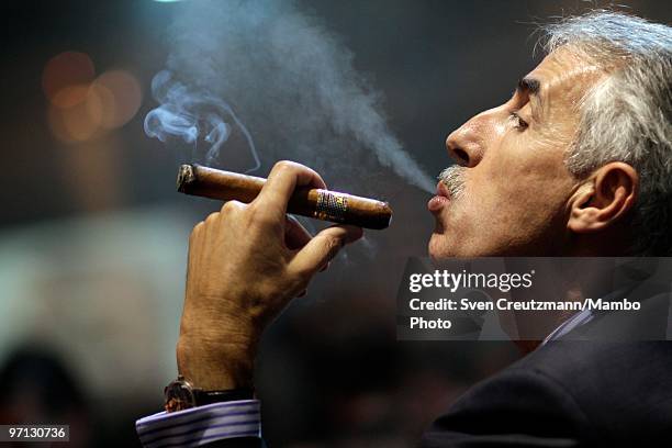 Man smokes his Cuban Cohiba cigar during an auction of humidors and gala dinner smoke Cuban cigars at the end of the annual five day Habanos Tobacco...