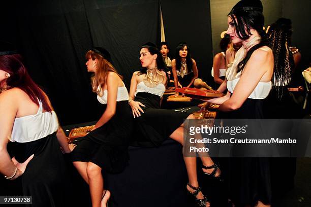 Cuban models get ready to bring Cuban Cohiba Cigars to the guests at an auction of humidors and gala dinner smoke Cuban cigars at the end of the...