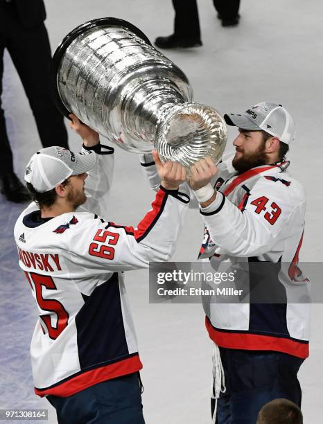 Andre Burakovsky of the Washington Capitals takes the Stanley Cup from Tom Wilson after the team's 4-3 win over the Vegas Golden Knights in Game Five...