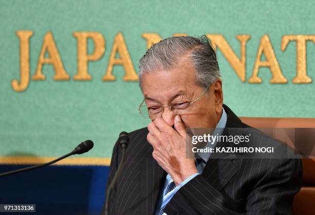 Malaysian Prime Minister Mahathir Mohamad reacts as he answers questions during a press conference at the Japan National Press Club in Tokyo on June...