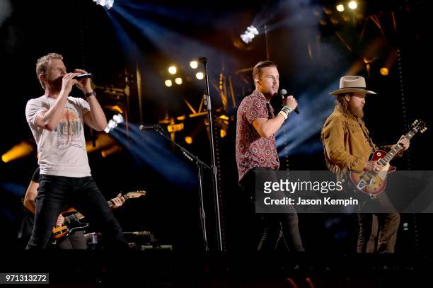 Dierks Bentley, T.J Osborne and John Osborne of musical duo Brothers Osborne perform onstage during the 2018 CMA Music festival at Nissan Stadium on...