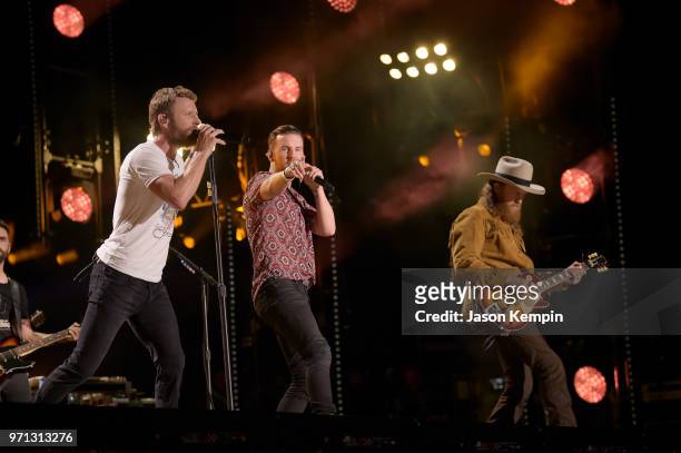 Dierks Bentley, T.J Osborne and John Osborne of musical duo Brothers Osborne perform onstage during the 2018 CMA Music festival at Nissan Stadium on...