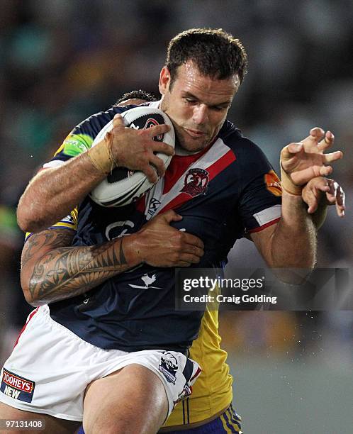 Nate Myles of the Roosters is tackled during the NRL trial match between the Sydney Roosters and the Parramatta Eels at Bluetongue Stadium on...