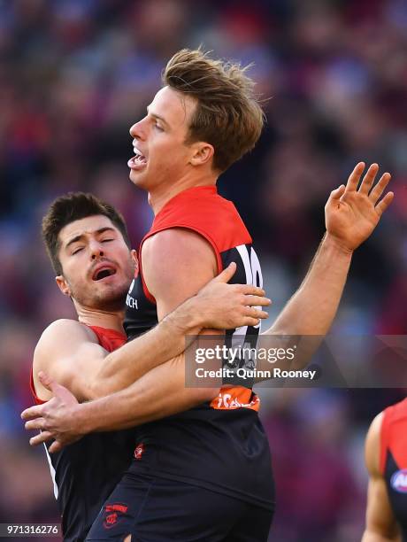 Mitch Hannan of the Demons is congratulated by Alex Neal-Bullen after kicking a goal during the round 12 AFL match between the Melbourne Demons and...