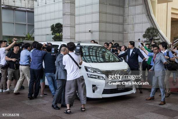 Members of the press surround the car of North Korean vice-foreign minister Choe Son Hui as she leaves the Ritz-Carlton hotel following a meeting...