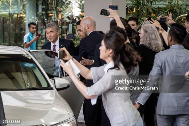 Members of the press rush to interview United States Ambassador to the Philippines Sung Kim as he leaves the Ritz-Carlton hotel after meeting with...