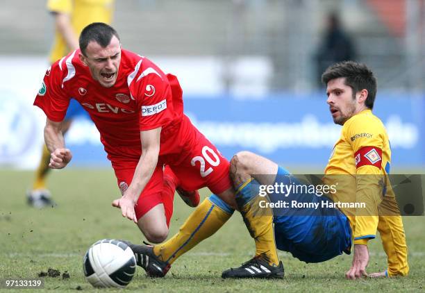 Dennis Kruppke of Braunschweig gets tackled by Mirnes Mesic of Offenbach during the Third Liga match between Eintracht Braunschweig and Kickers...