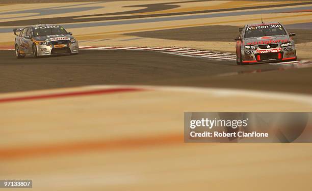 Jamie Whincup driving the Team Vodafone Holden leads Mark Winterbottom driving the Ford Performance Racing Ford during race two for round two of the...