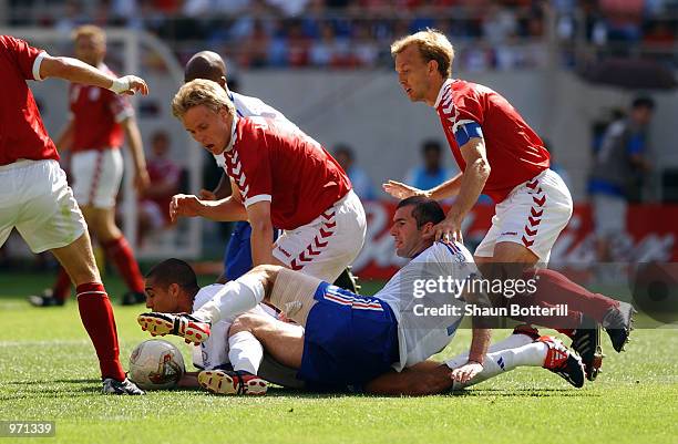 Zinedine Zidane of France falls over team-mate David Trezeguet while Martin Laursen and Rene Henriksen of Denmark look on during the FIFA World Cup...