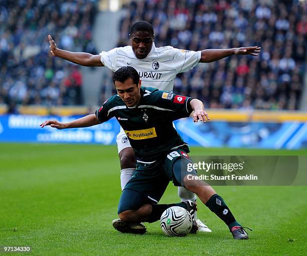 Juan Arango of Moenchengladbach is challenged by Cedric Makiadi of Freiburg during the Bundesliga match between Borussia Monchengladbach and SC...
