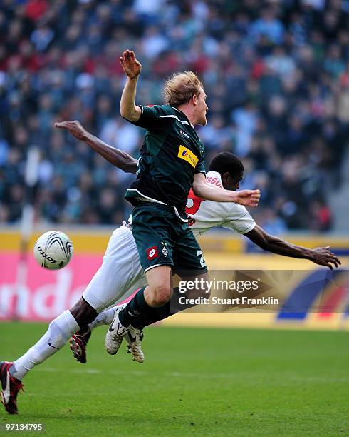 Tobias Levels of Moenchengladbach challenges Mohamadou Idrissou of Freiburg during the Bundesliga match between Borussia Moenchengladbach and SC...