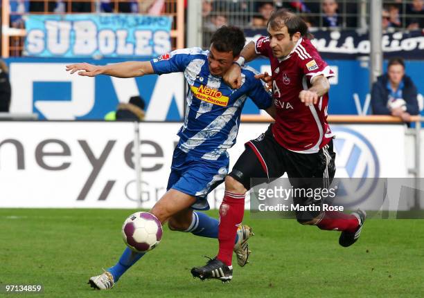 Roman Prokoph of Bochum and Javier Pinola of Nuernberg compete for the ball during the Bundesliga match between VFL Bochum and 1. FC Nuernberg at the...