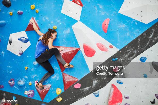 indoor wall climbing and bouldering extreme sports - bouldering stock pictures, royalty-free photos & images