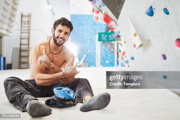 climber expert looking at camera during climbing activities. - chalk bag stock pictures, royalty-free photos & images