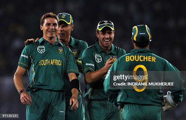 South African cricketer Dale Steyn is congratulated by teammates Johan Botha , AB de Villers and Mark Boucher for taking the wicket of unseen Indian...
