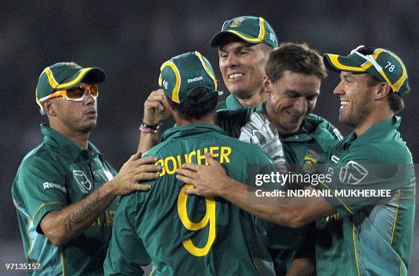 South African cricketer Dale Steyn is congratulated by teammates Herschelle Gibbs, Johan Botha, AB de Villers and Mark Boucher for taking the wicket...