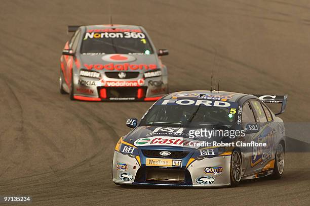 Mark Winterbottom driving the Ford Performance Racing Ford leads Jamie Whincup driving the Team Vodafone Holden during race two for round two of the...