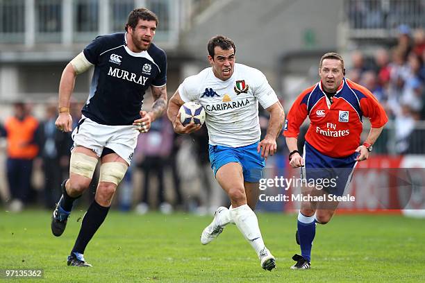 Andrea Masi of Italy bursts his way past Nathan Hines of Scotland during the RBS Six Nations match between Italy and Scotland at the Stadio Flaminio...