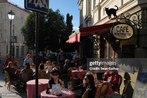 People sit at an outdoor cafe on June 6, 2018 in Vilnius, Lithuania. Vilnius is the capital of Lithuania and a popular tourist destination.