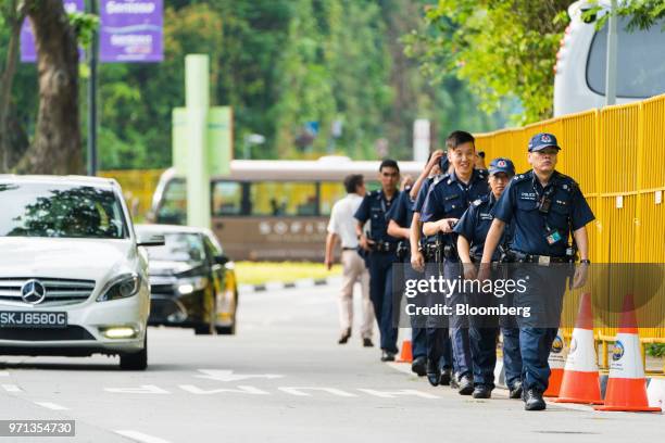 Police officers walk past barricades around the Capella Hotel in Singapore, on Monday, June 11, 2018. President Donald Trump is about to see whether...