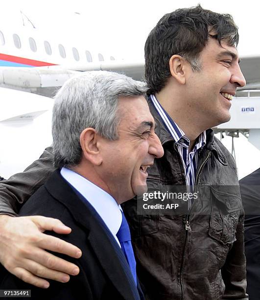 Georgian President Mikheil Saakashvili hugs his Armenian counterpart Serzh Sarkisian at the airport during President Serzh Sarkisian's friendly visit...