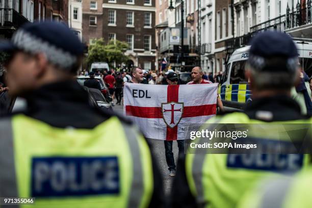 An EDL supporter seen holding an EDL flag in the counter-demo. Hundreds of anti-Israel protesters marched through the streets on the annual Al Quds...