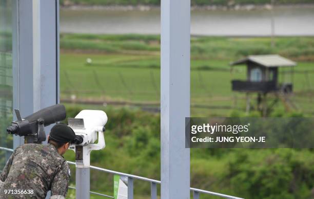 South Korean soldier looks through binoculars at a viewing deck of Imjingak peace park near the Demilitarised Zone dividing the two Korea's in the...