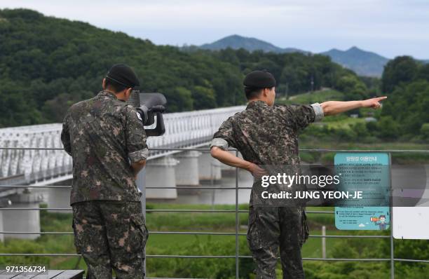 South Korean soldiers look through binoculars at a viewing deck of Imjingak peace park near the Demilitarised Zone dividing the two Korea's in the...