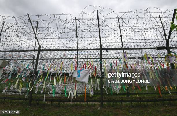 Ribbons with inscriptions calling for peace and reunification are displayed on a military fence at Imjingak peace park near the Demilitarised Zone...