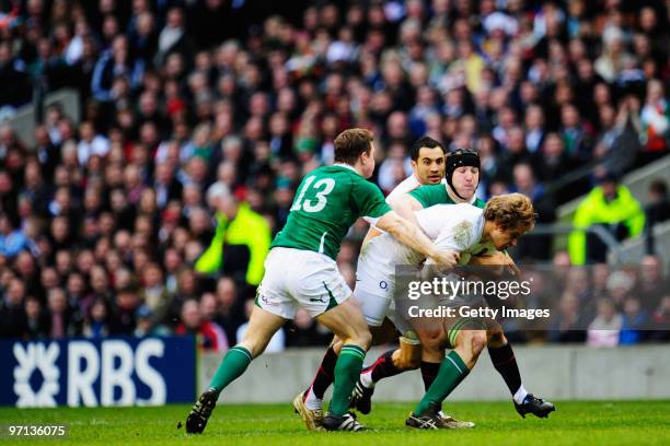 Mathew Tait of England is tackled by Brian O'Driscoll and Jamie Heaslip of Ireland during the RBS Six Nations match between England and Ireland at...