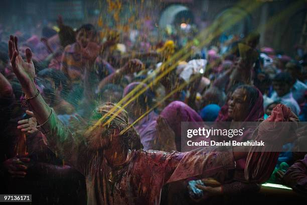 Hindu devotees play with colour during Holi celebrations at the Bankey Bihari Temple on February 27, 2010 in Vrindavan, India. The tradition of...